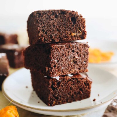 3 stacked sweet potato brownies on a white plate.