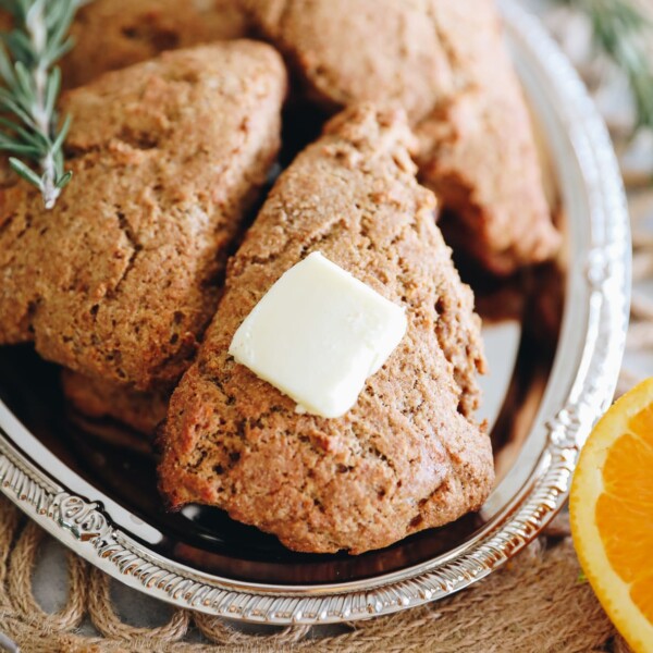 Close up shot of orange rosemary scones served on a silver platter.