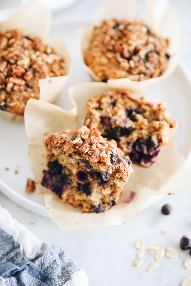 blueberry oatmeal muffins cut in half with a pecan streusel.