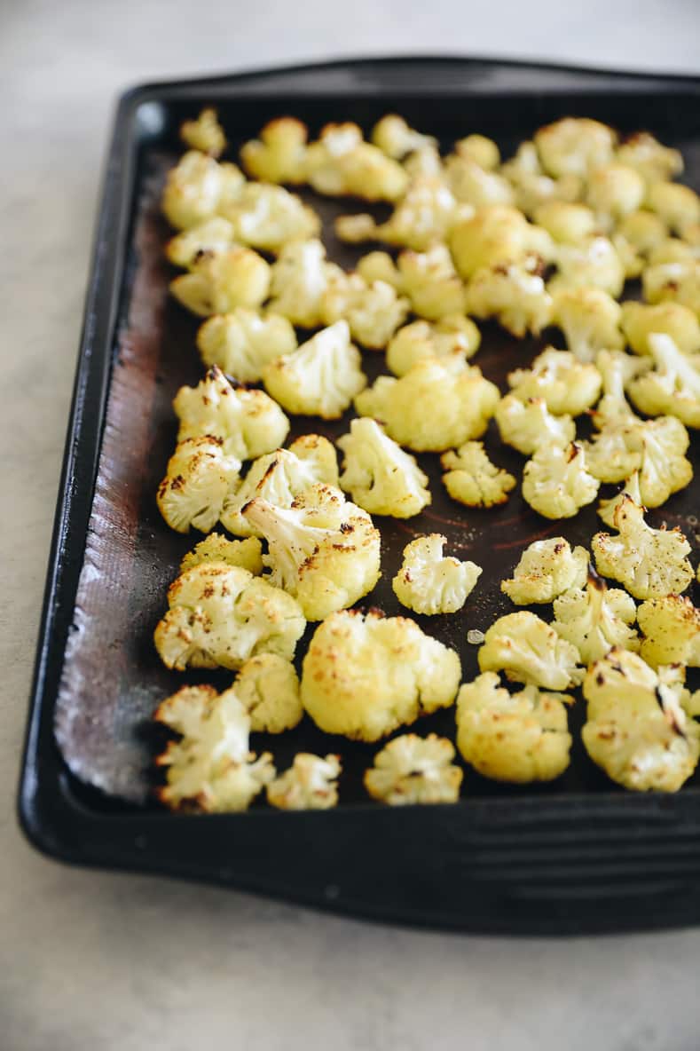 Roasted cauliflower on a baking sheet.