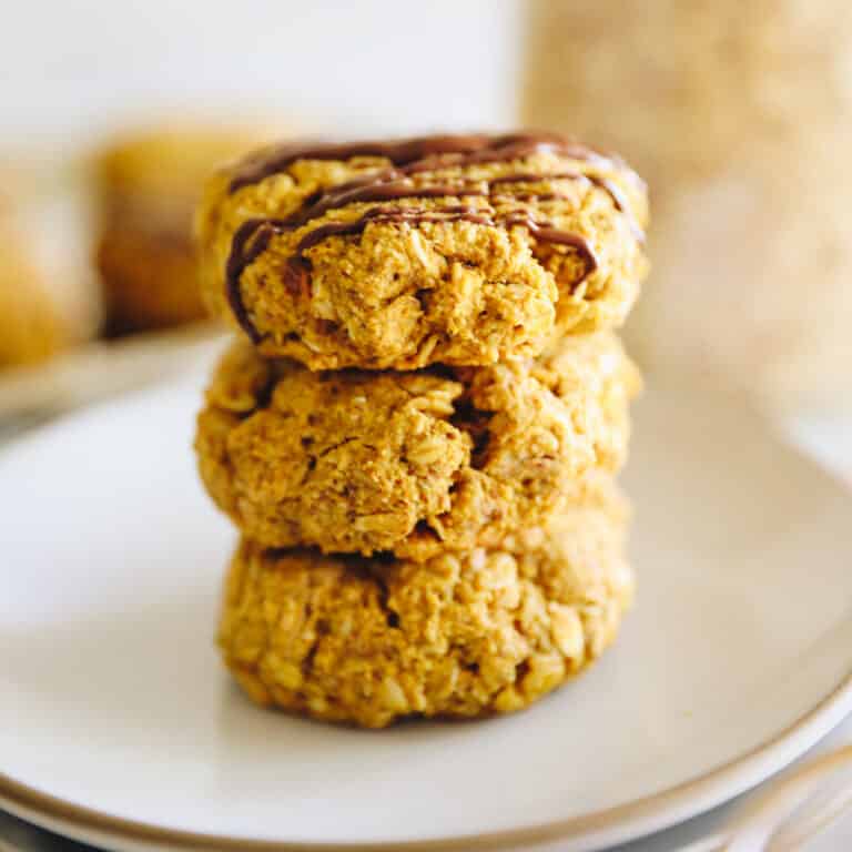 Stack of pumpkin breakfast cookies on a white plate.