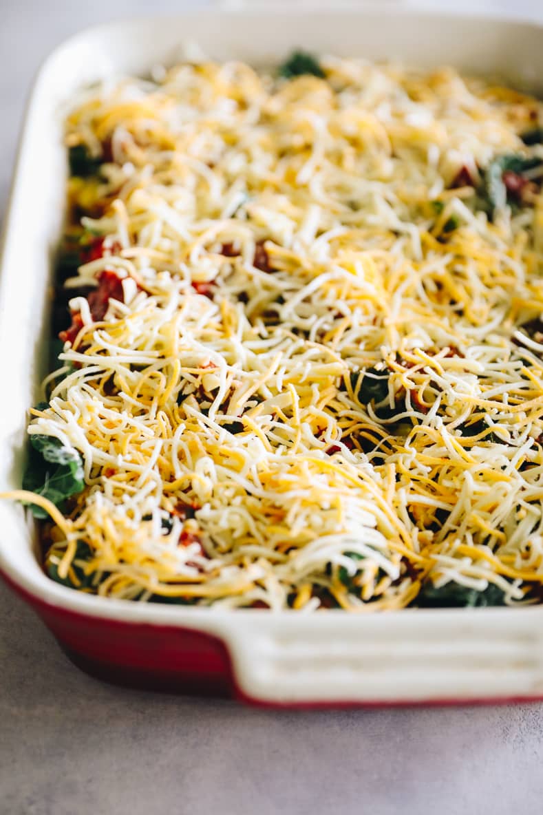 Angled shot of a quinoa taco casserole in a baking dish before baking.