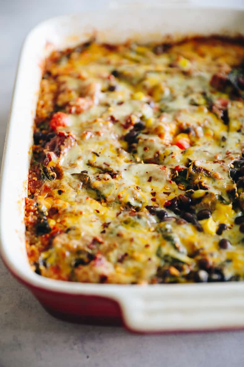 Angled shot of a quinoa taco casserole in a baking dish.