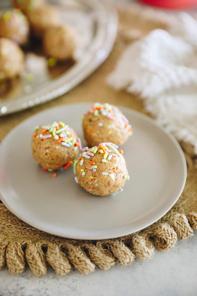 no-bake cake batter protein balls on a plate.