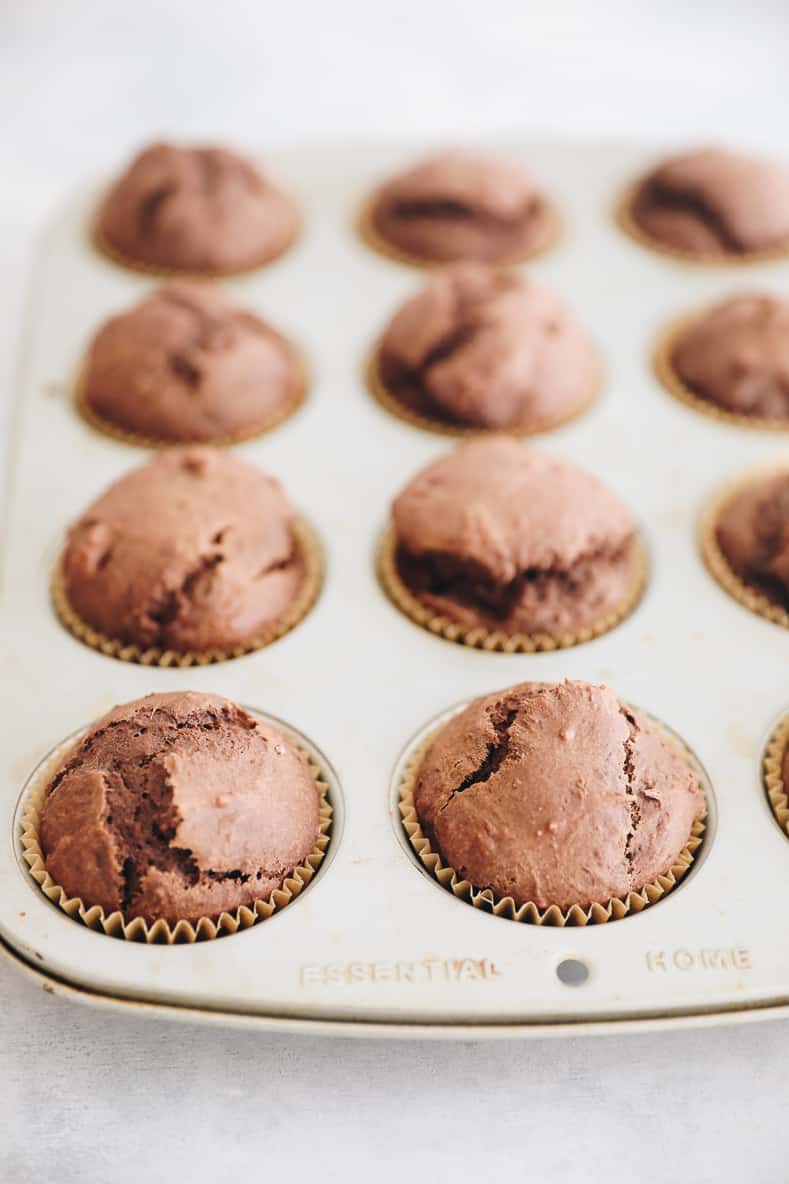 Chocolate gingerbread muffins in a muffin tin.