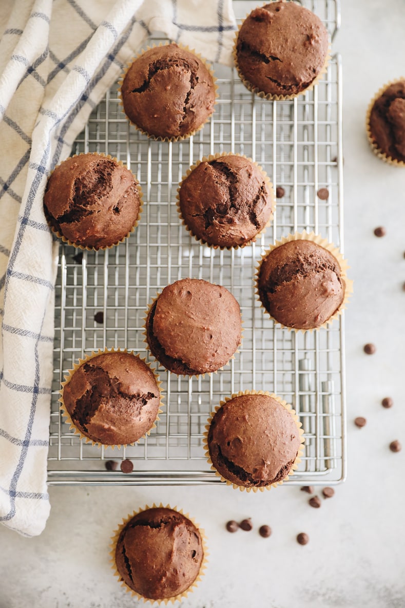 Overhead shot of chocolate gingerbread muffins cooling on a wire rack.