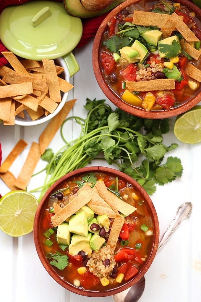 Swap the chicken for quinoa in this healthy vegetarian Quinoa Tortilla Soup recipe! Quinoa is high in fiber and protein and makes a great non-meat alternative in this spicy Mexican soup.