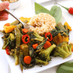 Plate with thai basil vegetable stir fry and brown rice. Fork taking a bite of rice and vegetables.