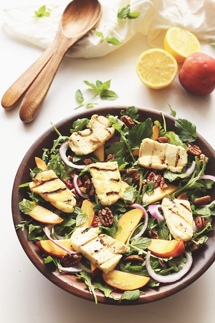 This Arugula Peach and Halloumi Salad is the summer salad I just can't get enough of! Tossed with pecans, onions and fresh mint and topped with a lemon vinaigrette, I have no doubts you will love this salad too!