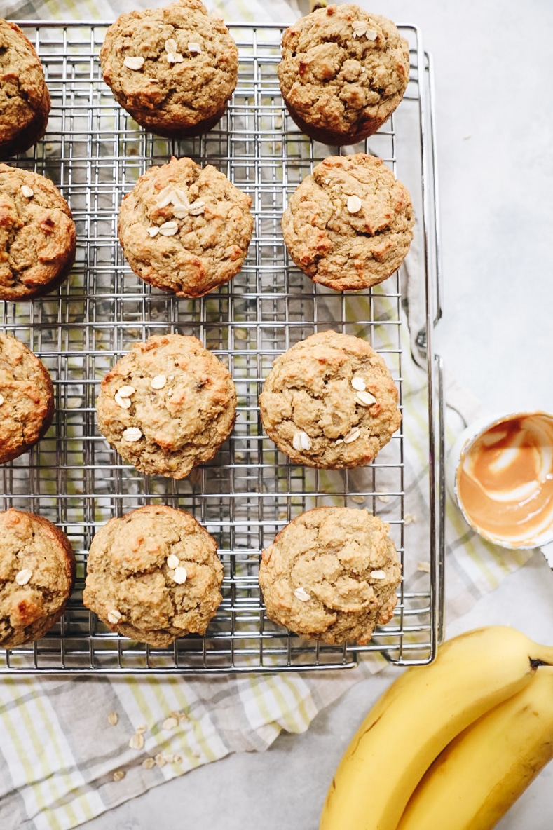 overhead image of oat banana peanut butter muffins on a wire rack.