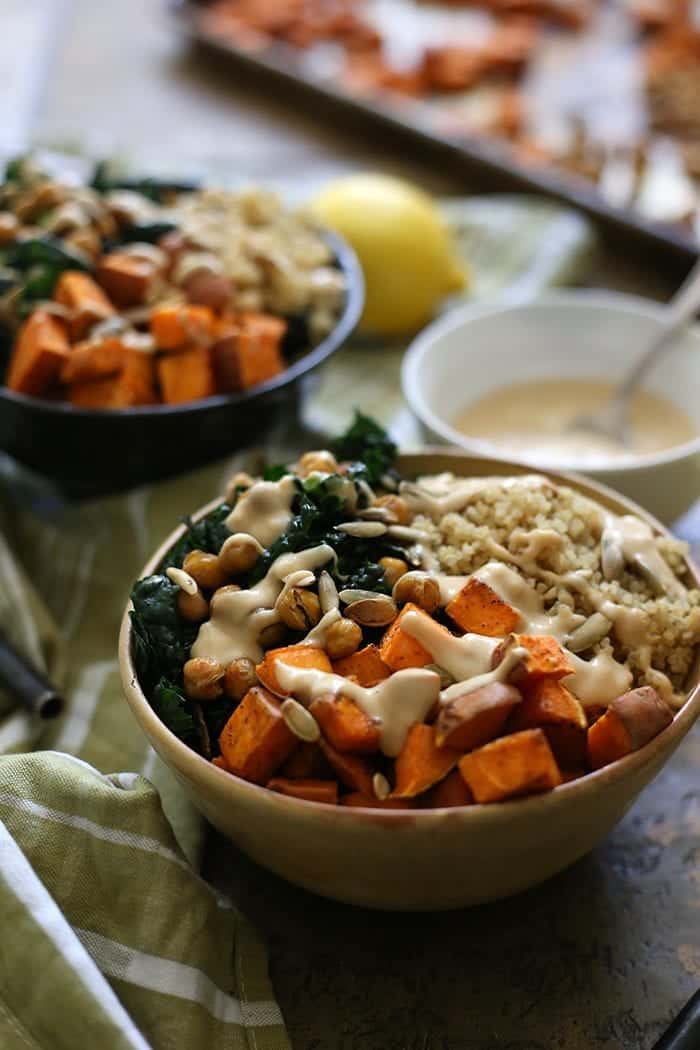 An easy, go-to vegetarian dinner recipe for Macro Veggie Bowls. Made with sweet potato, quinoa, crunchy chickpeas and greens topped with a tahini dressing, this dinner recipe will quickly become a staple at your healthy dinner table.