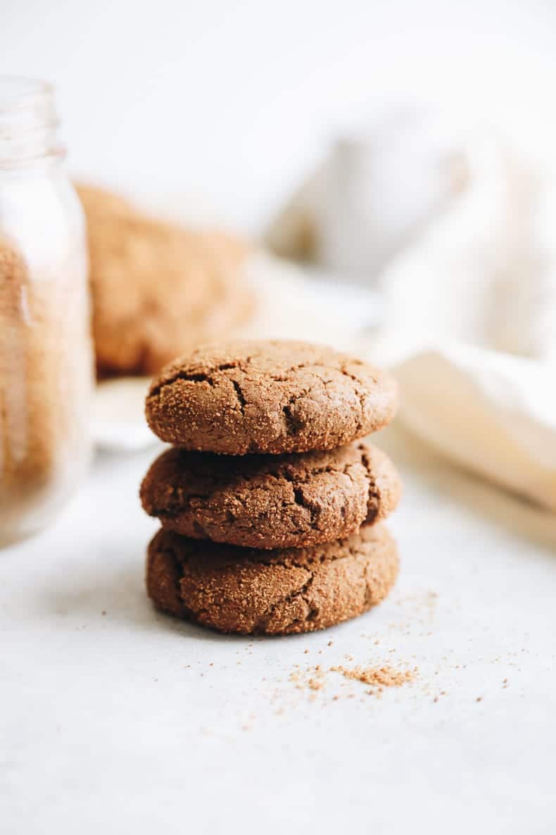 3 ginger molasses cookies stacked on top of each other on a counter