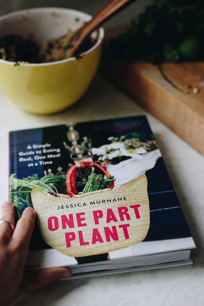 Image of the One Part Plant cookbook. Yellow mixing bowl in the background.