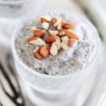 Close up shot of vanilla chia pudding in a glass dish topped with chopped almonds.