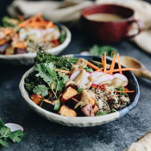 These customizable Quinoa Veggie Bowls with Miso Sesame Dressing will become a weeknight staple. With a quinoa and veggie base topped with a zesty and flavor-packed dressing this easy dinner or lunch recipe is a healthy vegan option for the whole family.