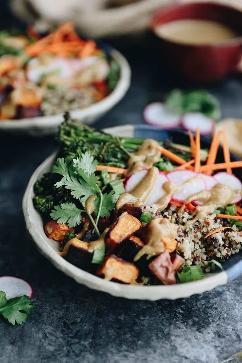 These customizable Quinoa Veggie Bowls with Miso Sesame Dressing will become a weeknight staple. With a quinoa and veggie base topped with a zesty and flavor-packed dressing this easy dinner or lunch recipe is a healthy vegan option for the whole family.