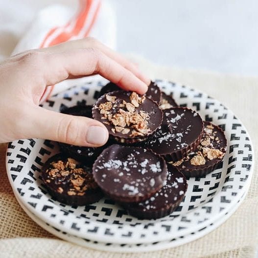 Switch up your Peanut Butter Cup game with these Tahini Butter Cups with Honey Candied Cereal sprinkled on top for a sweet treat with a twist. This delicious chocolate dessert recipe is sweetened entirely with honey for a healthier swap! #tahini #tahinibuttercups