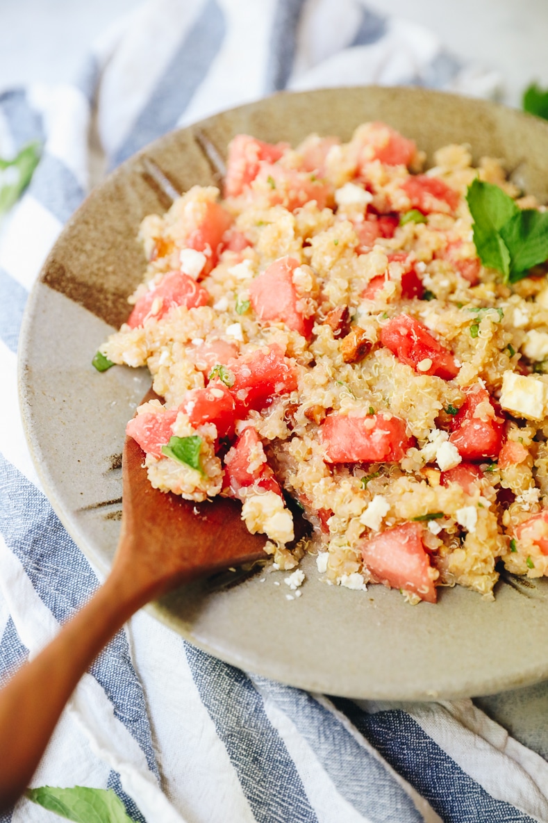 quinoa salad with watermelon, feta and mint in a brown serving bowl.