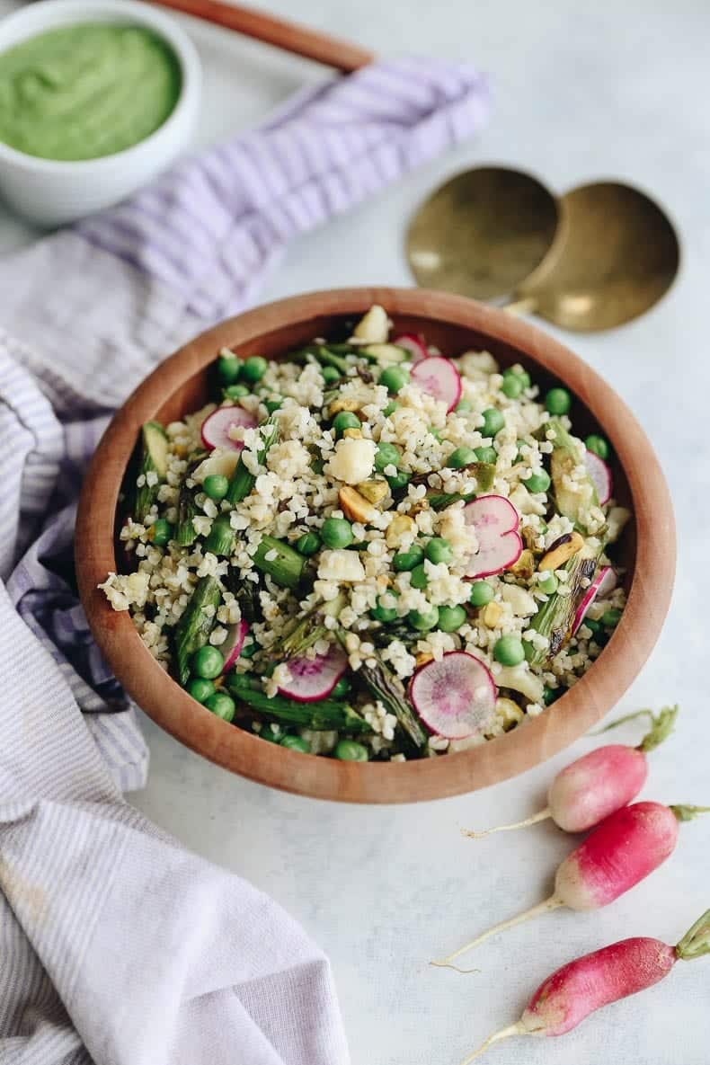 Celebrate the arrival of spring with this Spring Bulgur Wheat Salad with Avocado Herb Dressing. This bulgur salad is simple to make and full of delicious ingredients made from the spring harvest. #bulgurwheat #springsalad