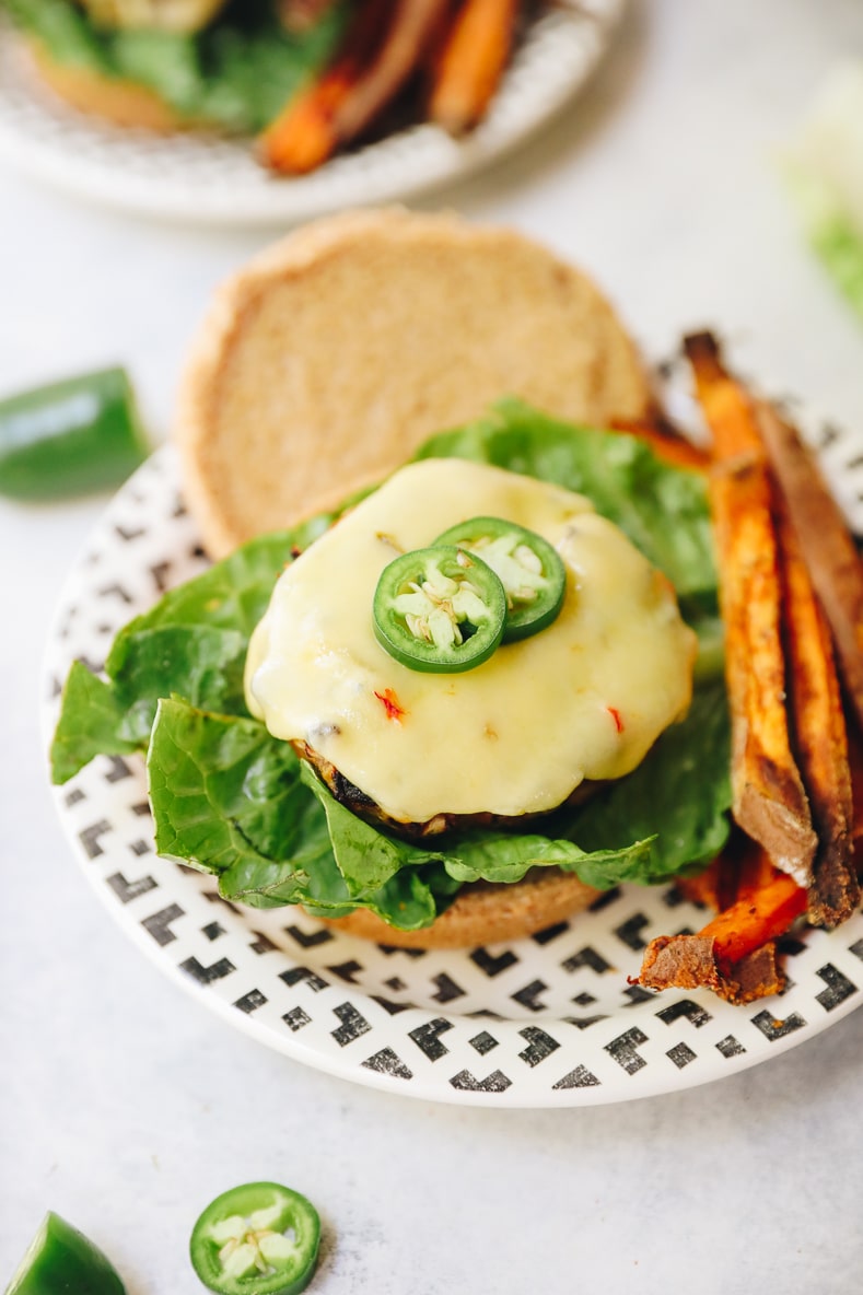 jalapeno turkey burger on a bun with melted cheddar jack cheese and fresh jalapenos.