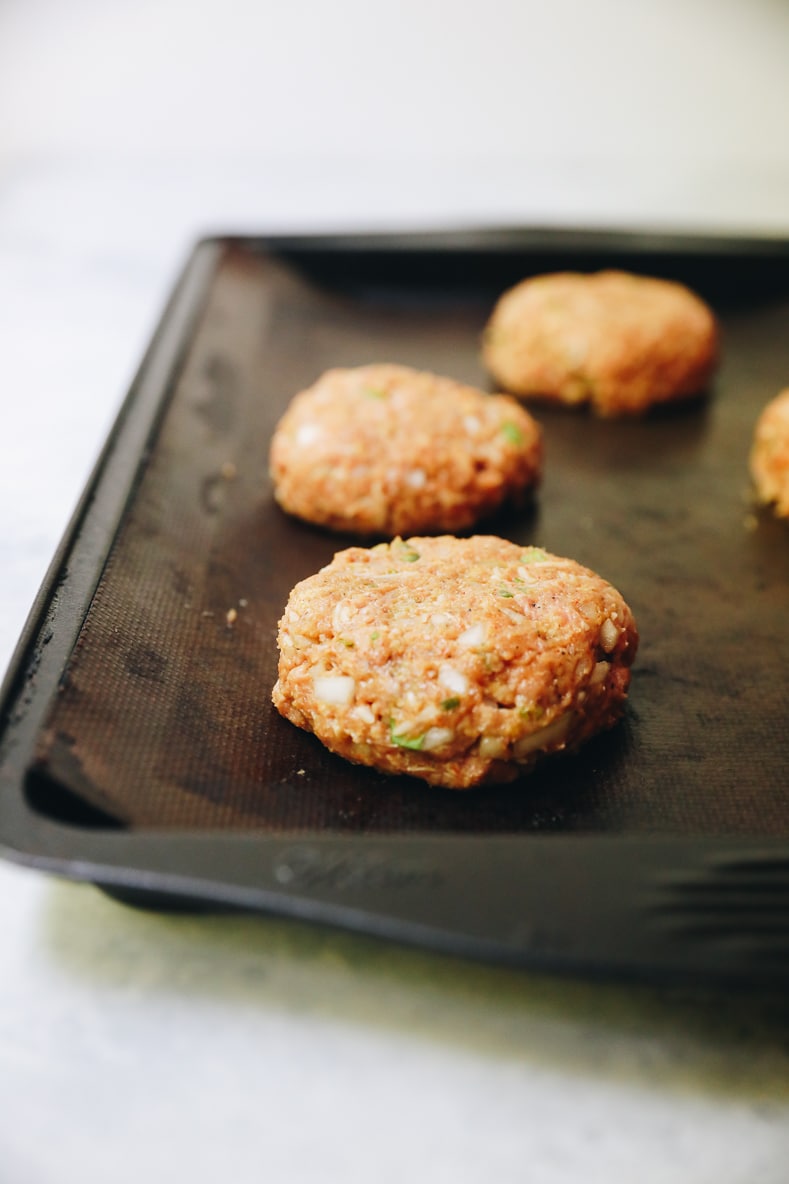 raw jalapeno turkey burgers on a baking pan.