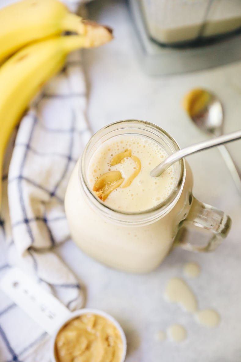overhead image of a peanut butter banana smoothie with a drizzle of peanut butter