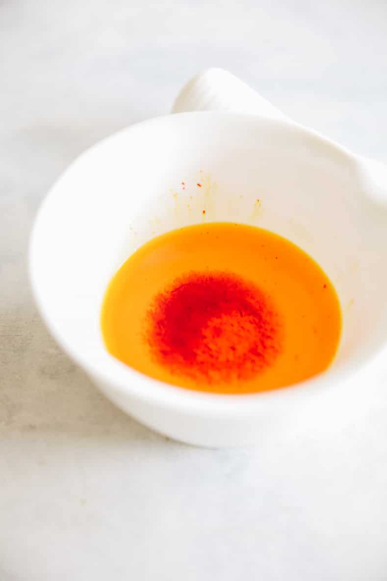 soaked saffron in a mortar and pestle for saffron rice recipe