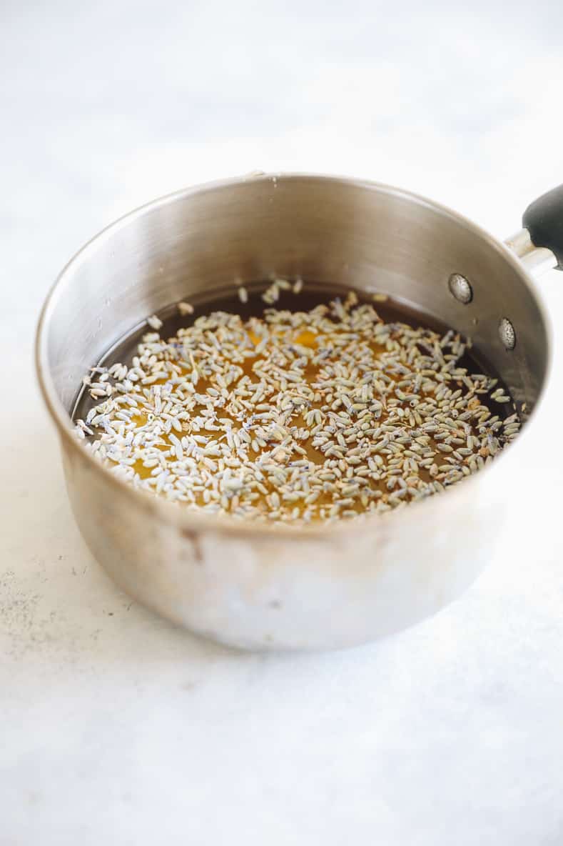 lavender buds infusing into a lavender simple syrup in a small pot