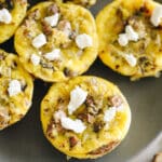 Close up shot of egg muffins topped with goat cheese.