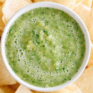 Close up shot of small dish of green salsa.