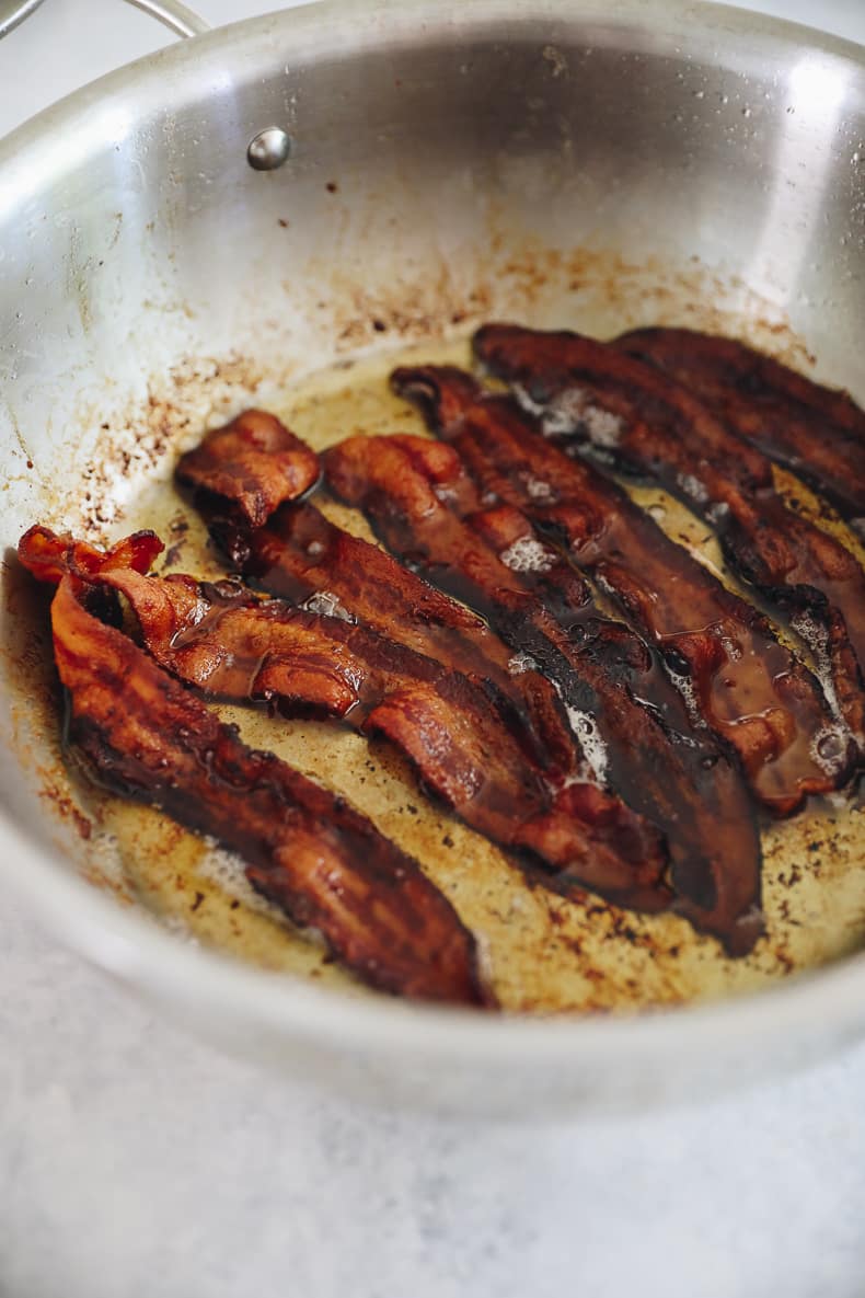 crispy bacon in a pan as preparation for freezer breakfast burritos