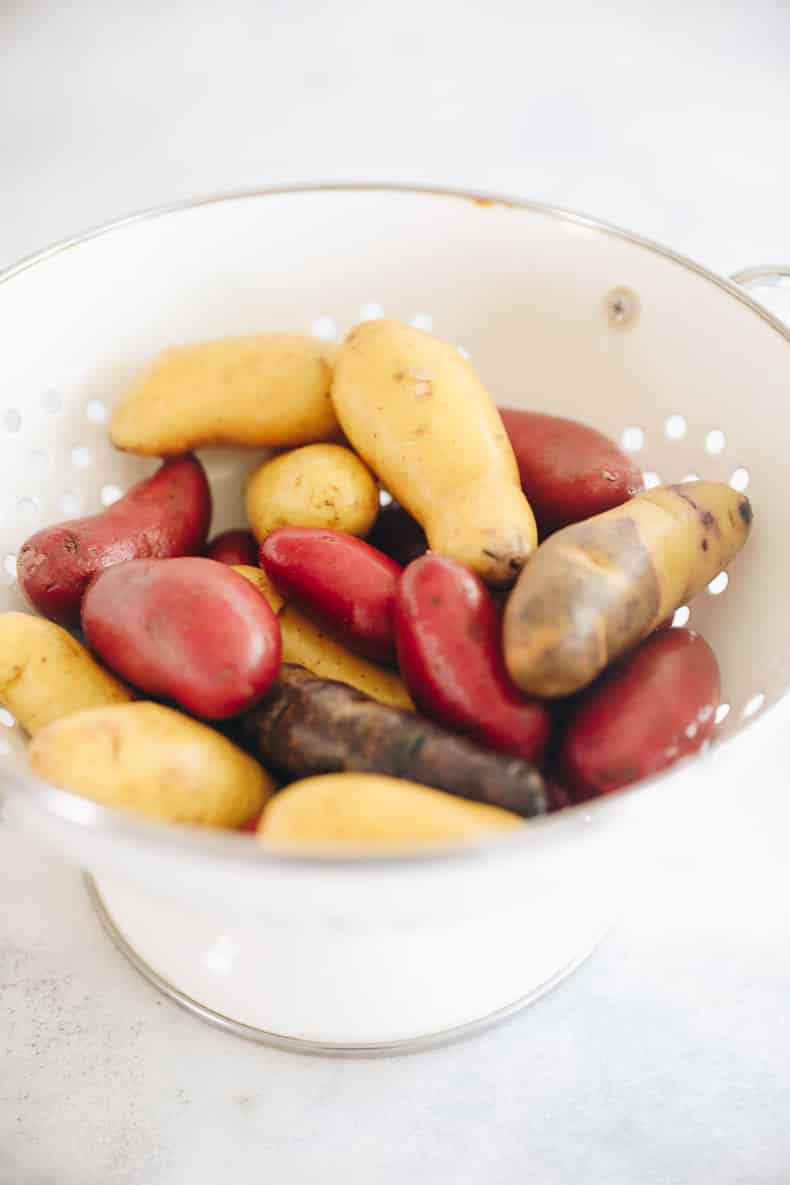 Washed and dried raw fingerling potatoes in a colander