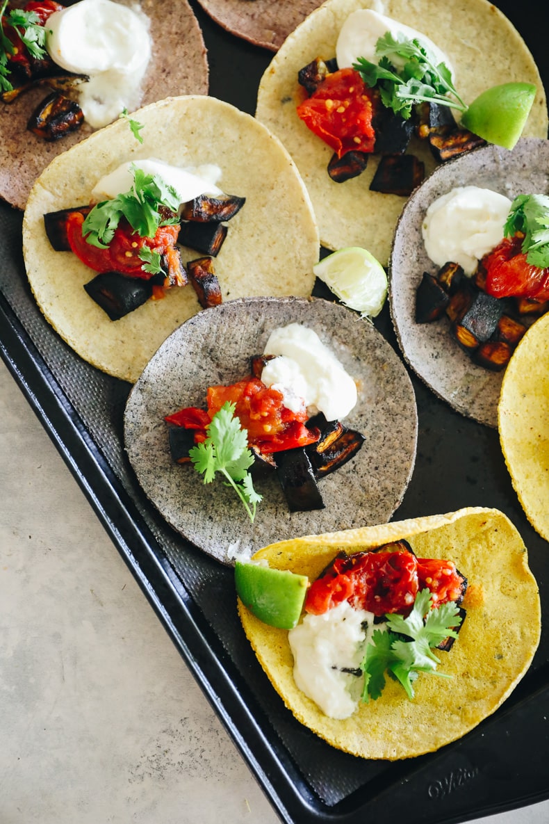 eggplant tacos laid out on a baking sheet