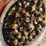 roasted brussel sprouts with balsamic on a silver platter.