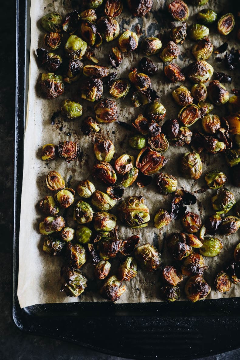 overhead photograph of roasted brussel sprouts with balsamic on a sheet pan.