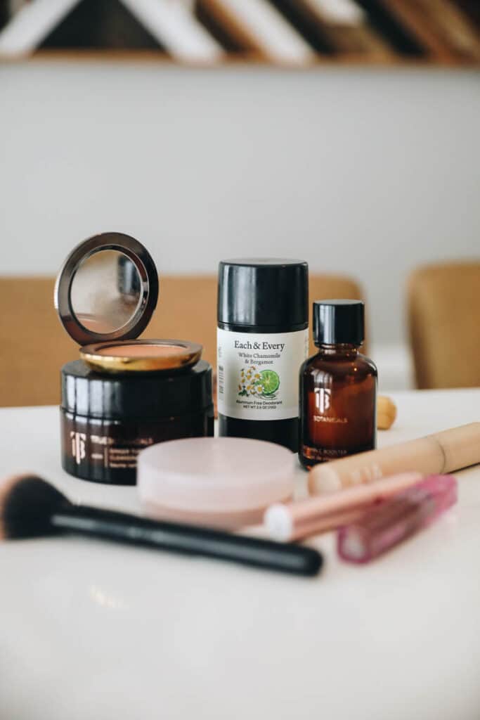 clean beauty products sitting on a counter. Featuring ILIA mascara, Kosas Cloudset, Westman Atelier Bronzer, True Botanicals