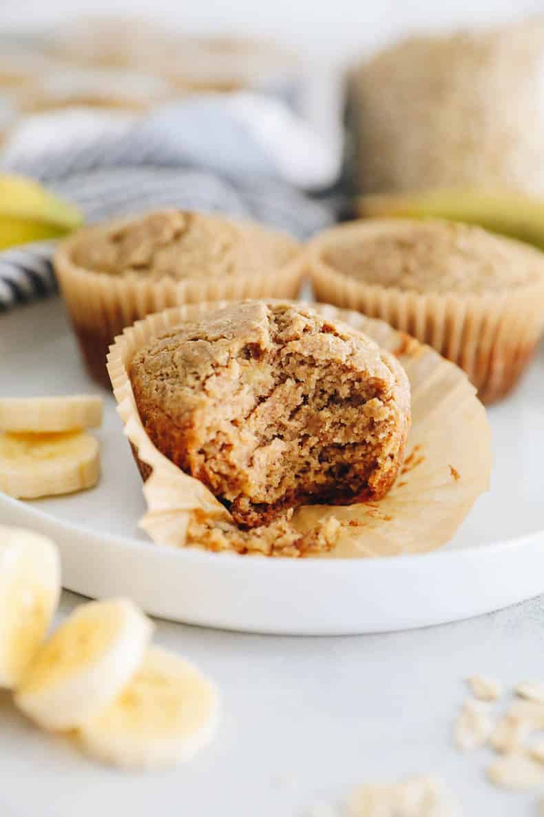 Baby banana muffins with a bite removed.
