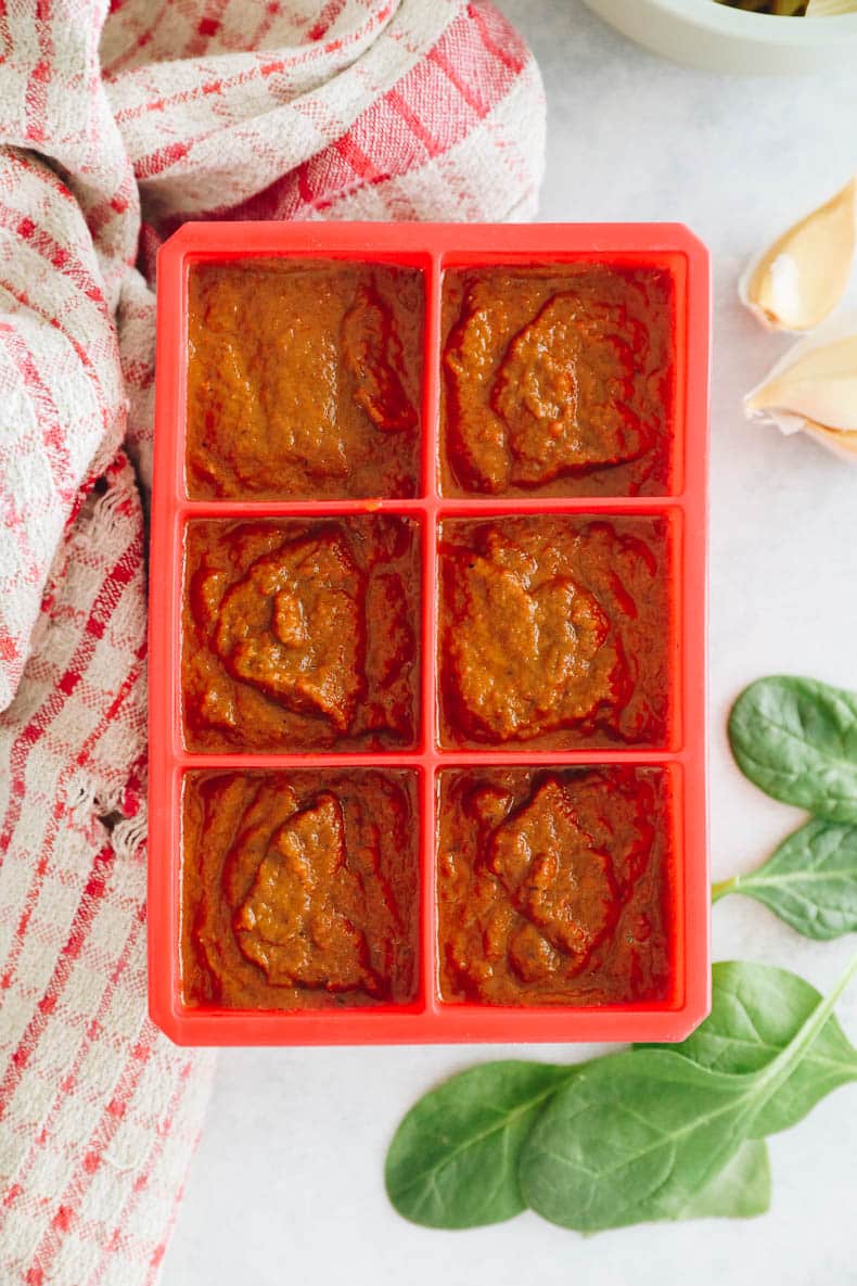 Hidden veggie tomato sauce in a red 3 oz ice cube tray for freezing.