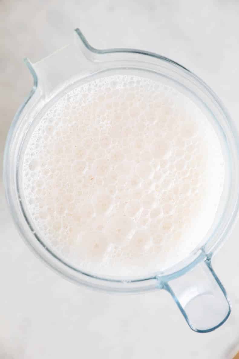 foamy almond milk after being blended in a blender.