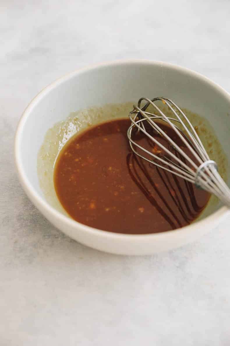 miso glaze for salmon in a small bowl with a whisk.