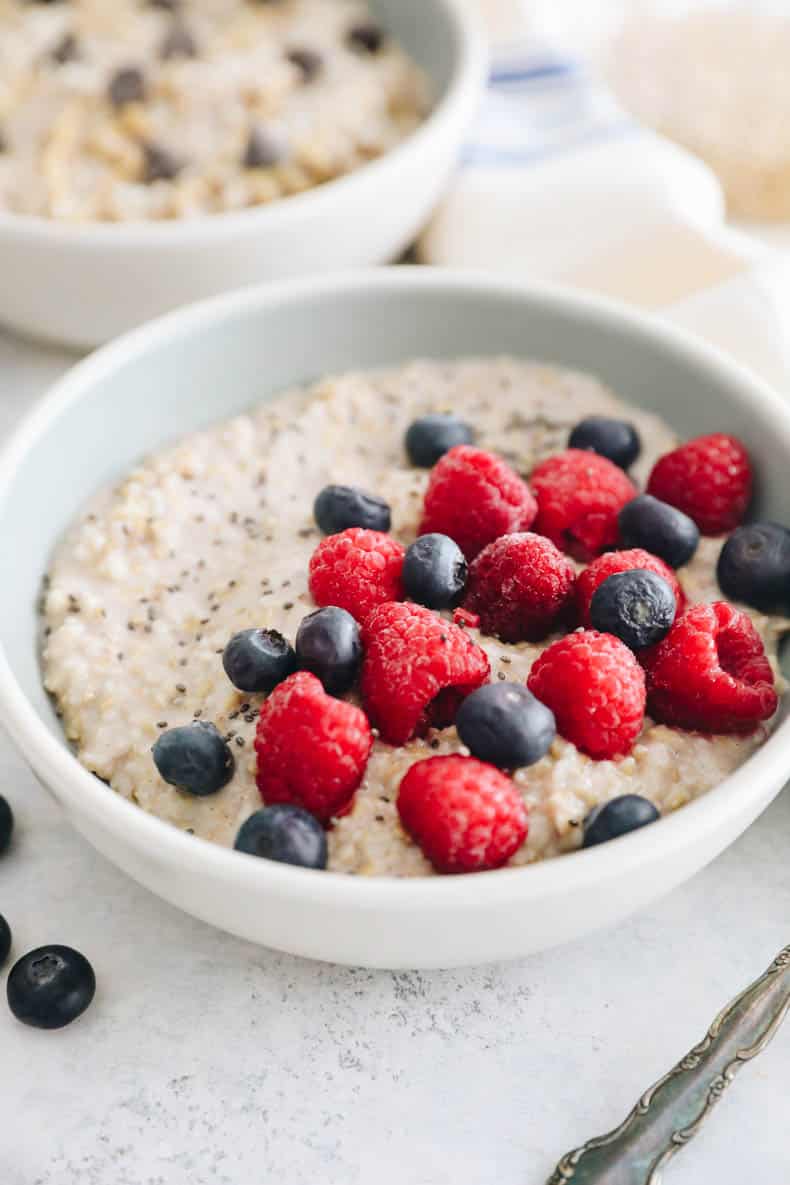 steel cut oats in a bowl with blueberries, raspberries and chia sseds.