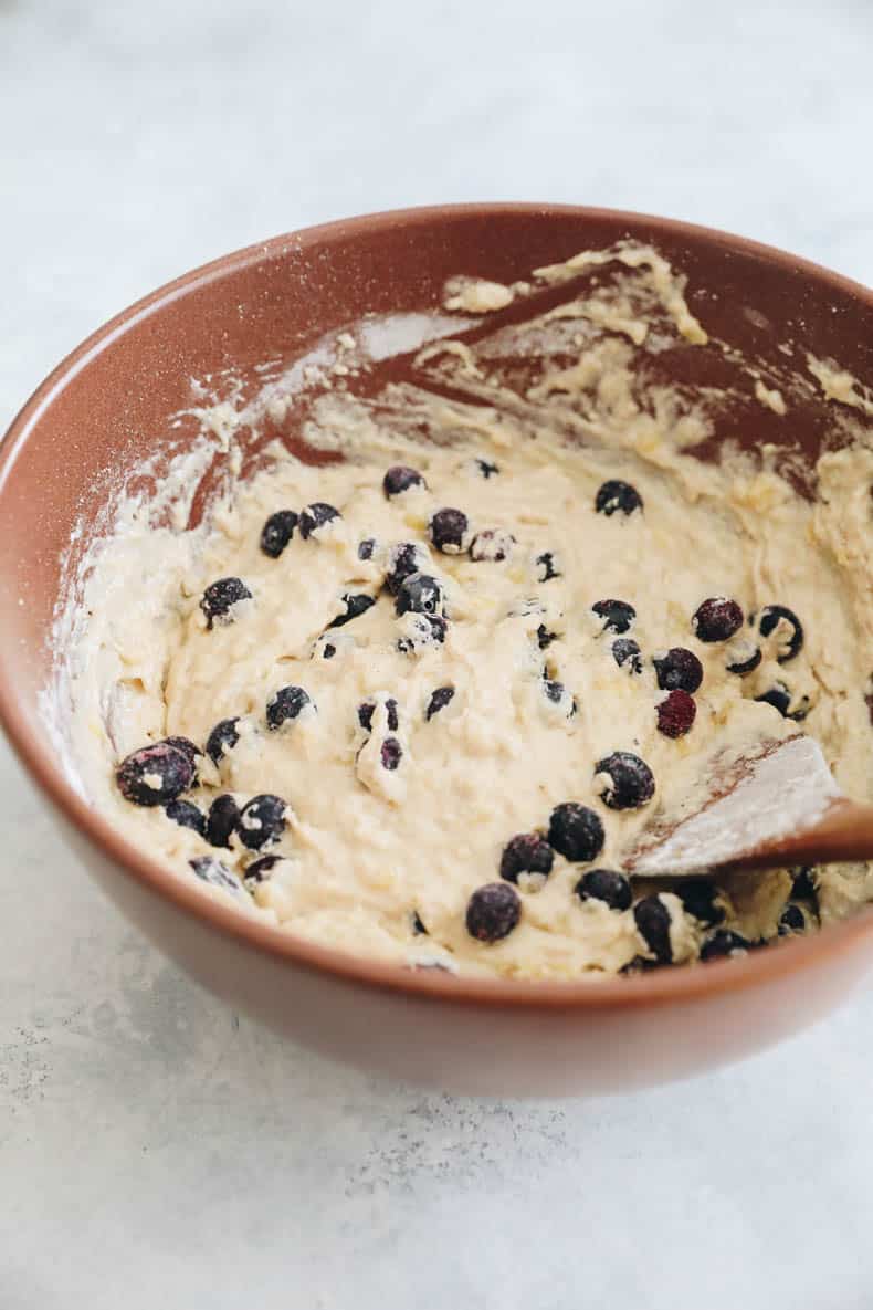 banana blueberry muffin batter in a mixing bowl.