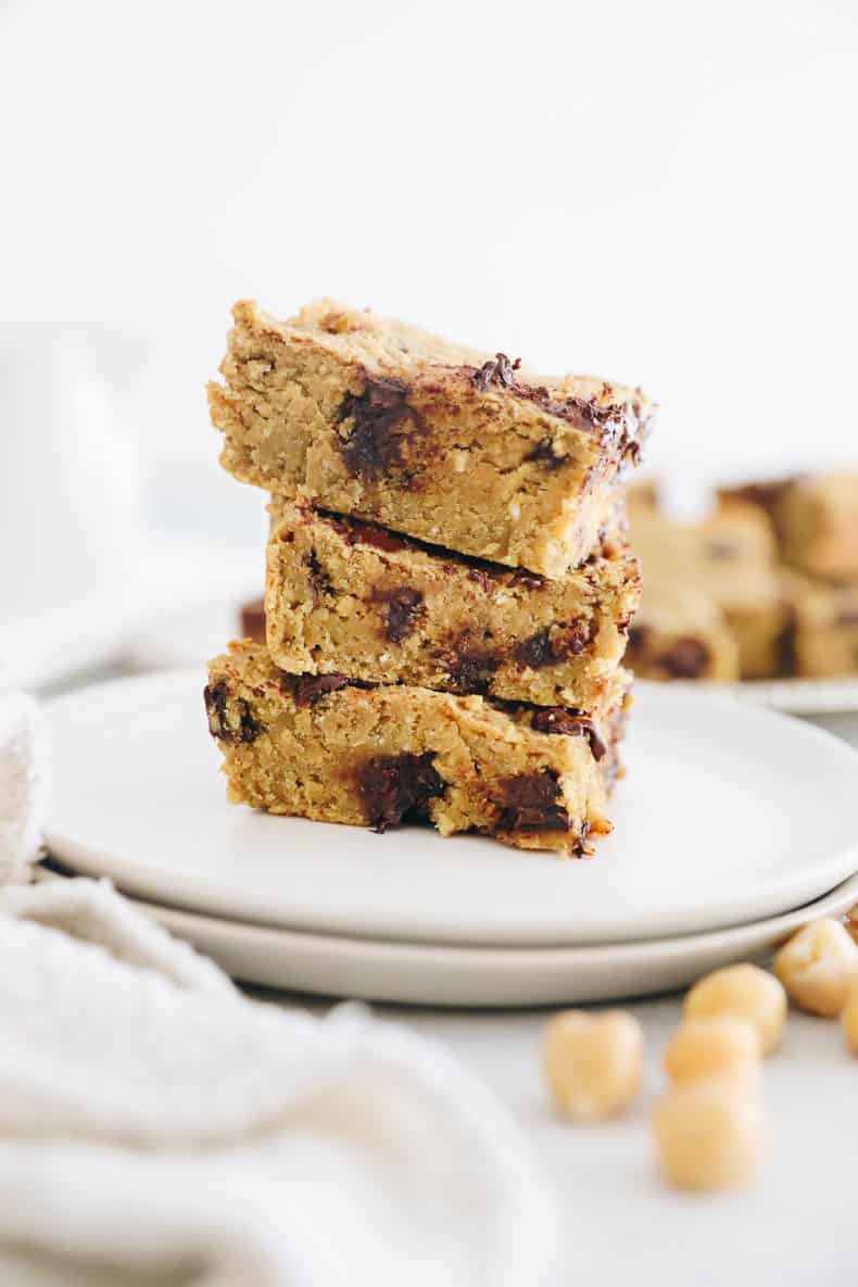 chickpea blondies stacked on a small white plate.