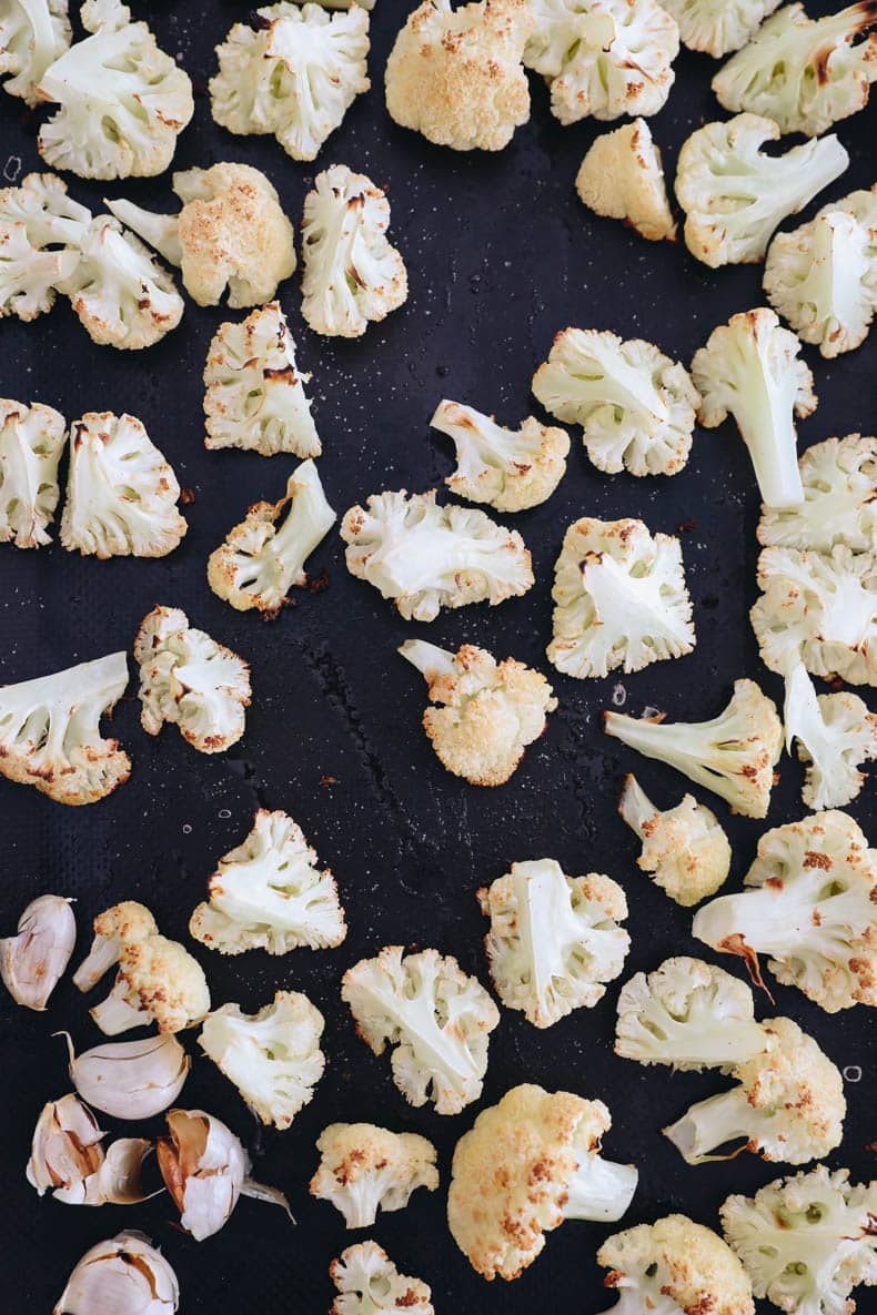 roasted cauliflower and garlic on a sheet pan.