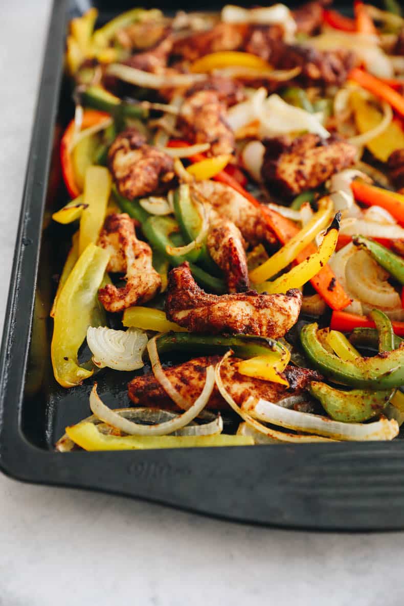chicken and veggies in fajita seasoning baked on a sheet pan