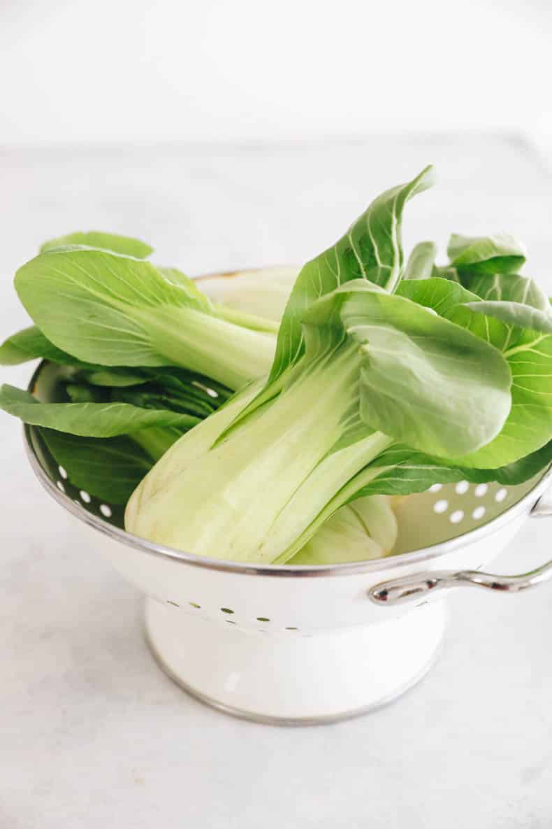 Baby bok choy in a colander.