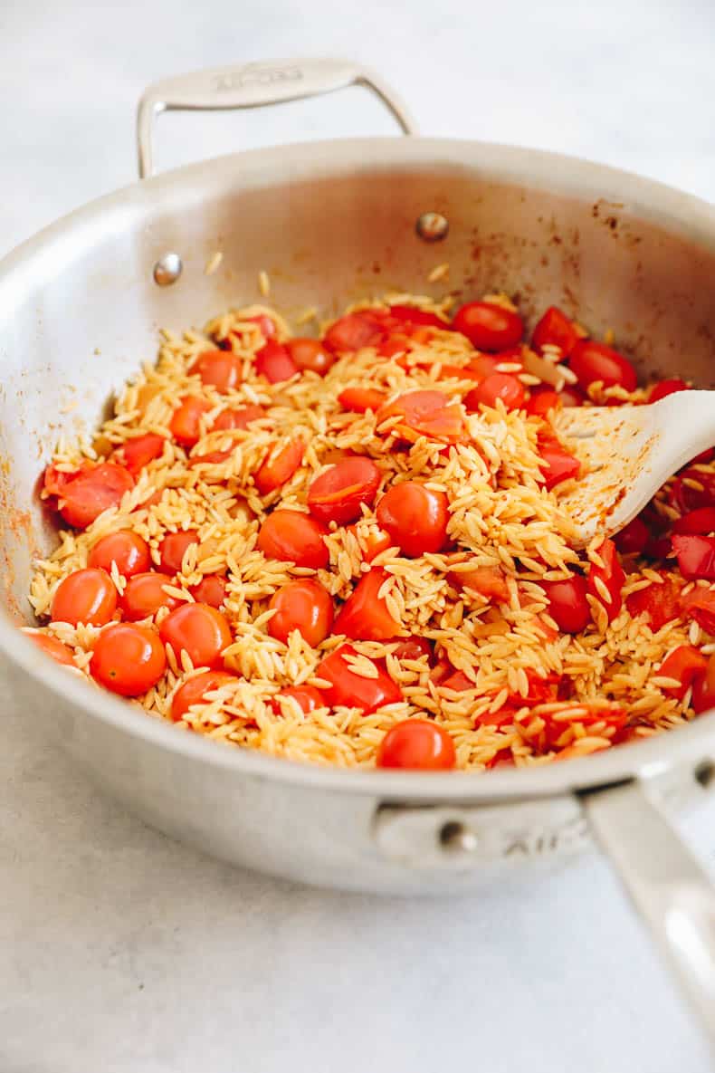 greek chicken orzo cooking in a large pot.