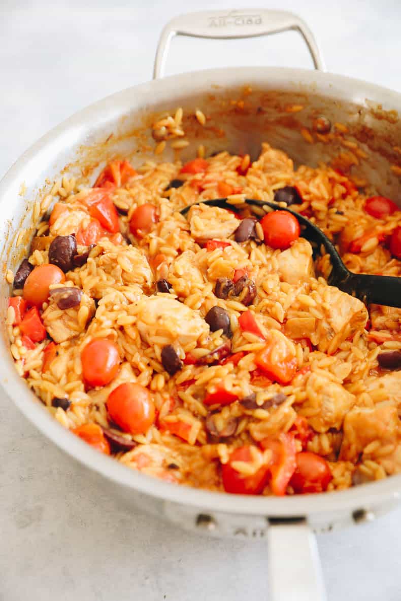 One-pan greek chicken orzo cooked in a large pot.