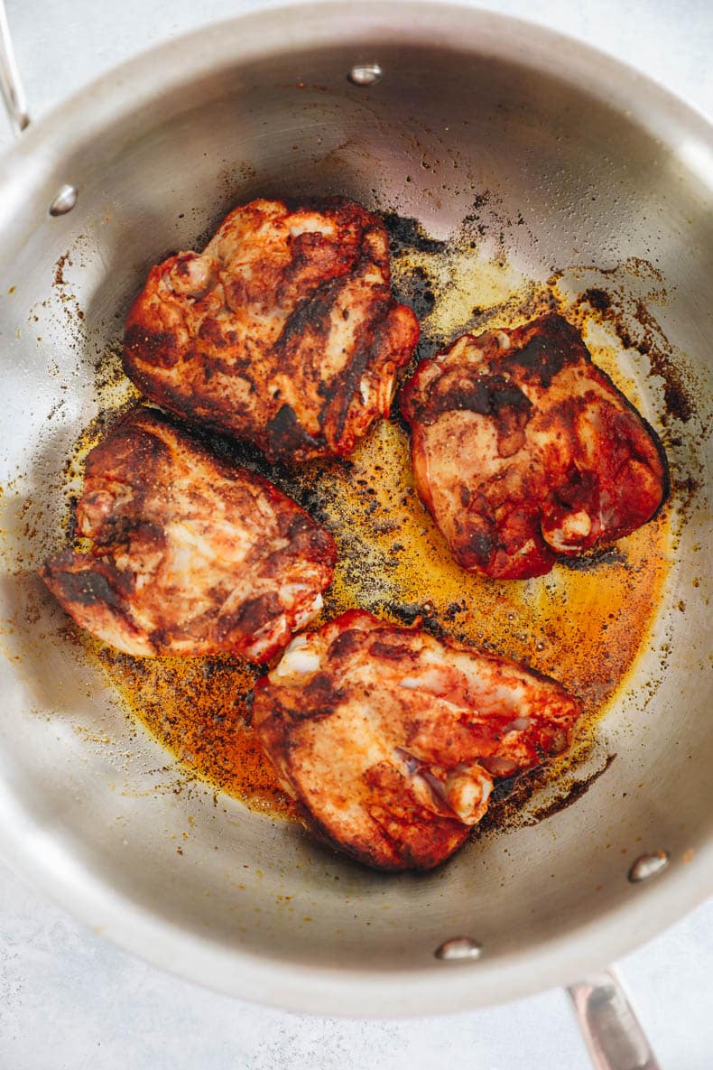 browned paprika chicken thighs in a large pot.