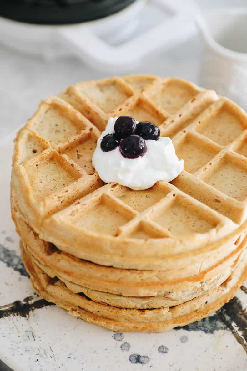 stack of protein waffles topped with greek yogurt and blueberries